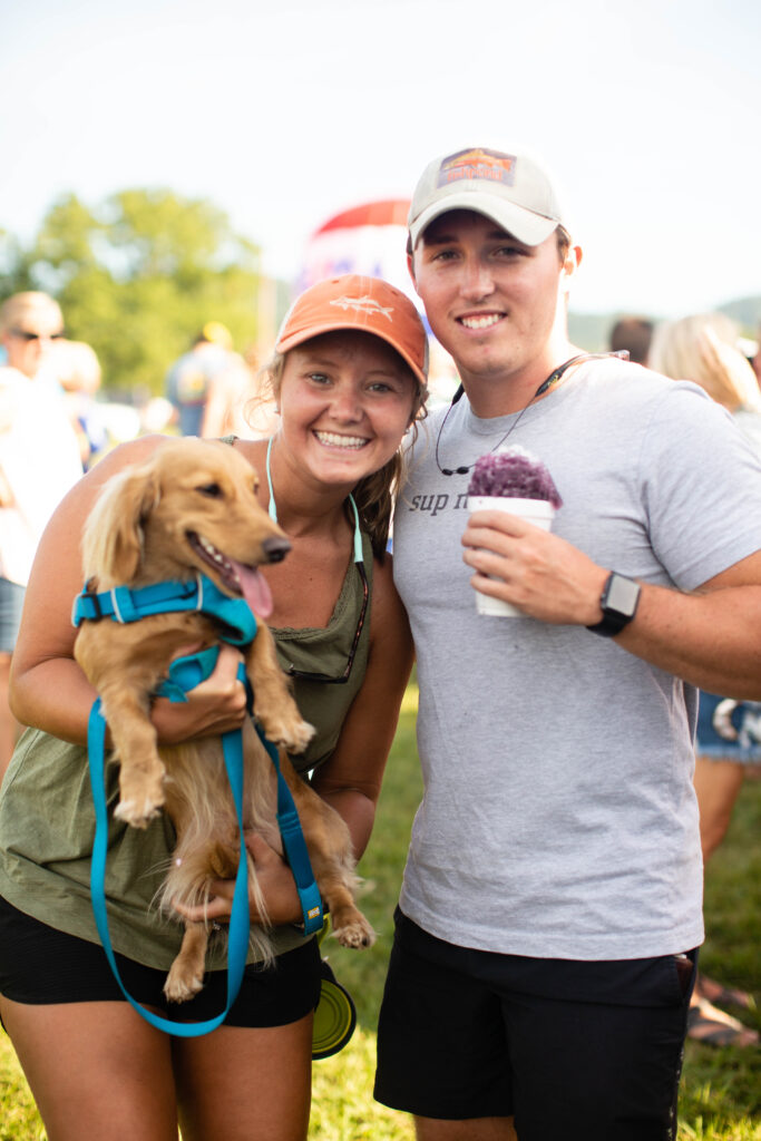 couple with their dog at the great smoky mountain hot air balloon festival
