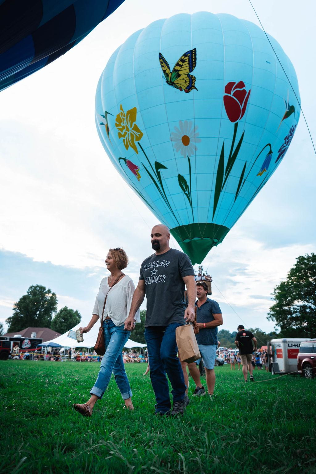 couple in front of flower and butterfly hot air balloon